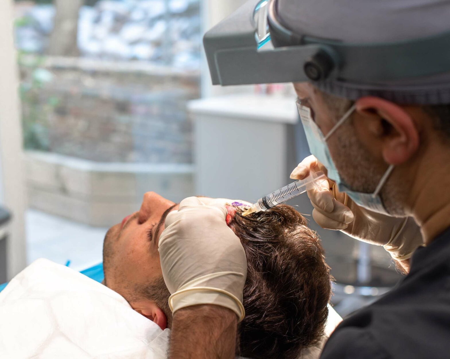 A person undergoing a hair transplant.